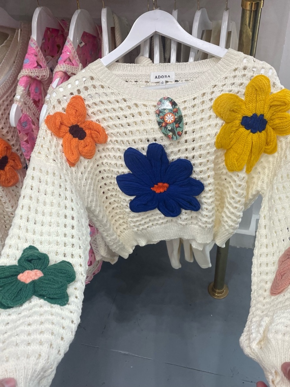 ADORA Cream Open-Knit Cropped Sweater with Multicolor Floral Appliqués